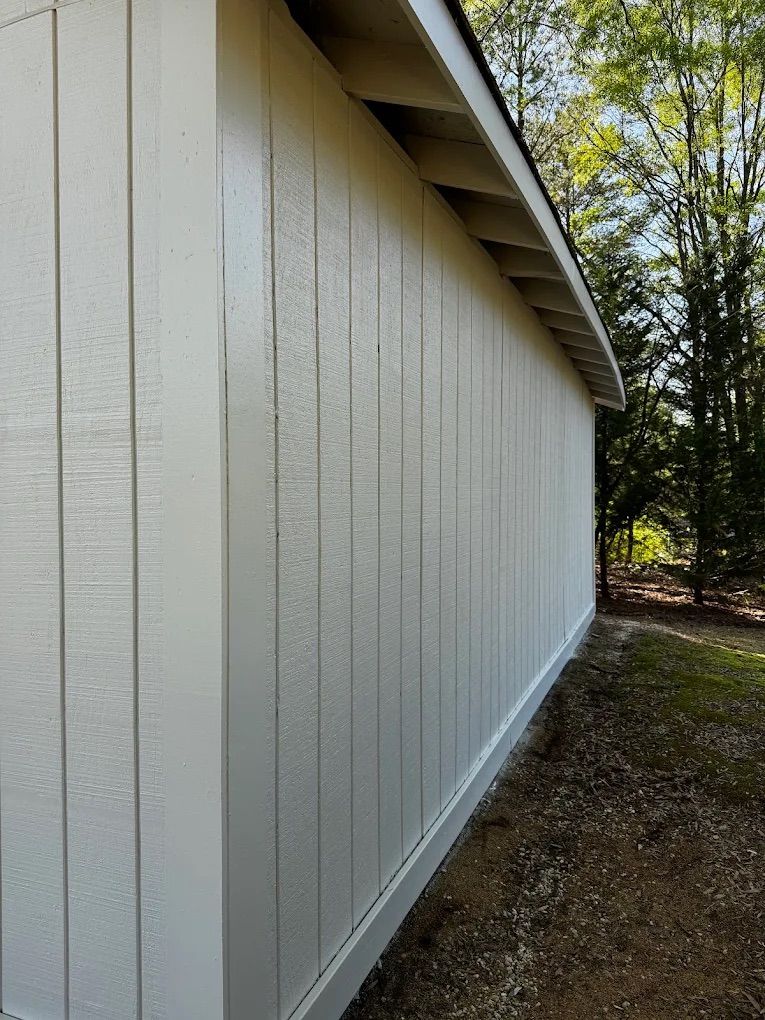 Close-up of freshly painted board and batten siding along a garage wall
