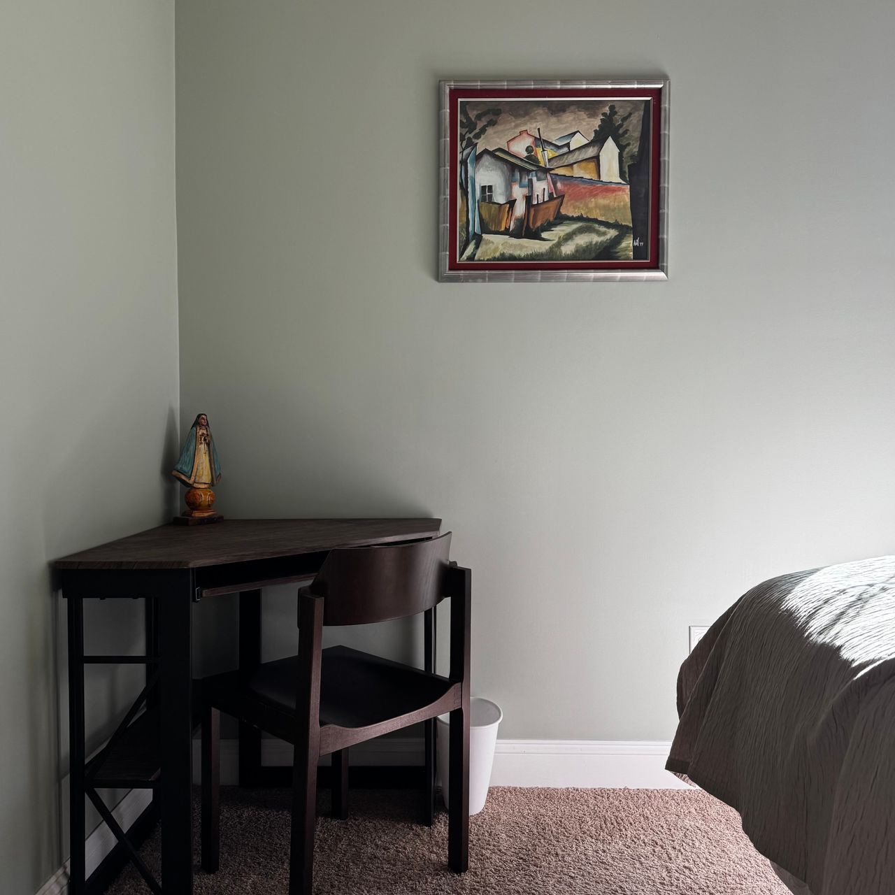 Bedroom wall painted pale sage green with a corner desk and framed painting, Duncan SC